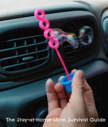 Blow bubbles as a car activity on a road trip with kids.
