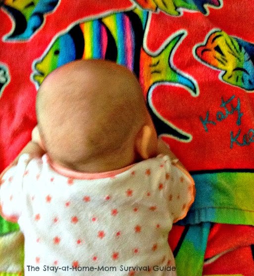Using a colorful beach towel for tummy time. Idea from The Stay-at-Home-Mom Survival Guide.