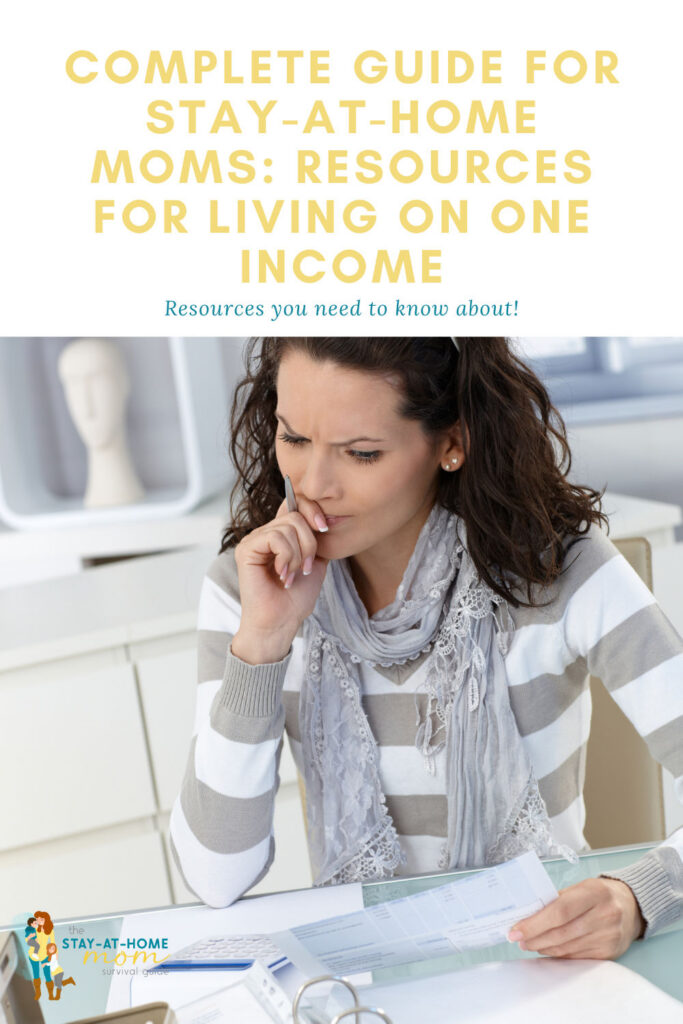 Woman looking pensively at her home binder. Text reads complete guide for stay at home moms resources for living on one income