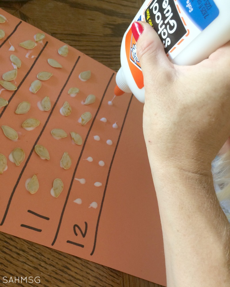 Gluing and fine motor exercise with a pumpkin seeds counting and number recognition activity.