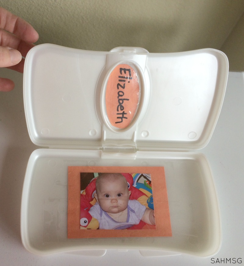 DIY Toy for Babies: Personalized Peek-A-Boo Box out of a travel wipes container.
