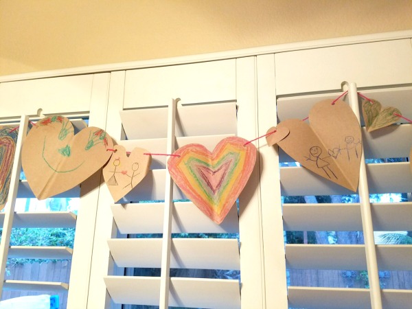 Valentine's banner crafts that kids can make! This is such a fun art expression activity that teaches scissor skills and fine motor skills too. It's a fun kids activity for Valentine's.