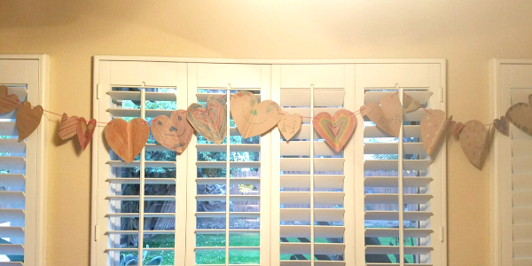 Valentine's banner crafts that kids can make! This is such a fun art expression activity that teaches scissor skills and fine motor skills too. It's a fun kids activity for Valentine's.