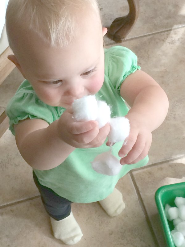 One item activities allow little ones to explore. This cotton ball toddler fine motor activity combines fine motor exploration with sensory and creativity. We made this into an indoor gross motor activity too. So much fun with one supply!