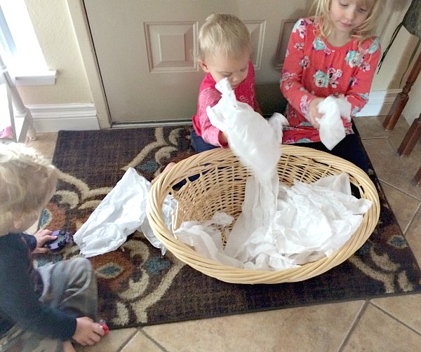 Too cold to play in the snow outside or don't have any snow where you live? Bring the snowball toss indoors for some gross motor fun for babies, toddlers, preschoolers and school age kids. This is so easy to set up with only two supplies. Great for indoor winter fun!