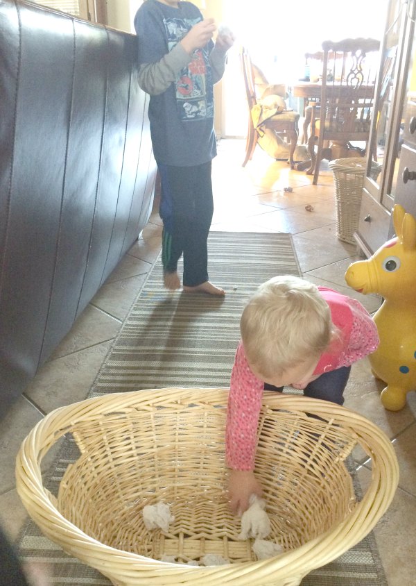 Too cold to play in the snow outside or don't have any snow where you live? Bring the snowball toss indoors for some gross motor fun for babies, toddlers, preschoolers and school age kids. This is so easy to set up with only two supplies. Great for indoor winter fun!