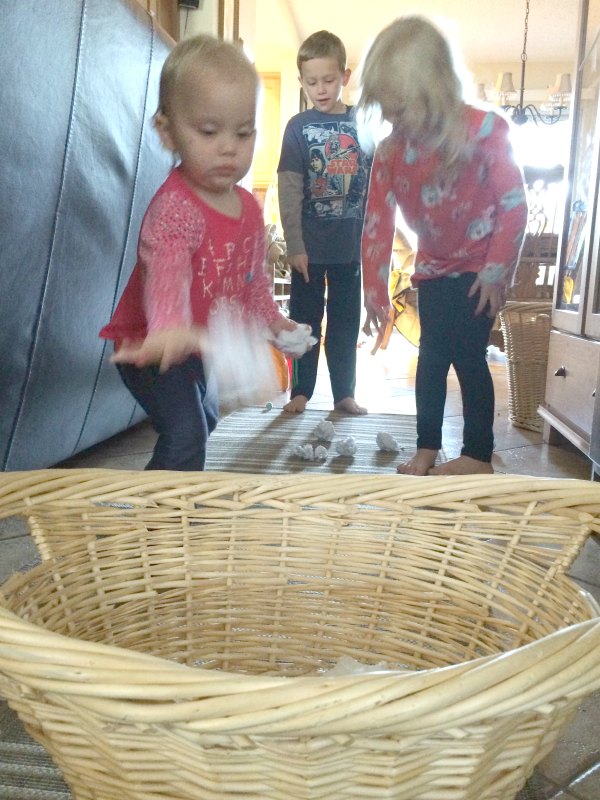 Too cold to play in the snow outside or don't have any snow where you live? Bring the snowball toss indoors for some gross motor fun for babies, toddlers, preschoolers and school age kids. This is so easy to set up with only two supplies. Great for indoor winter fun!