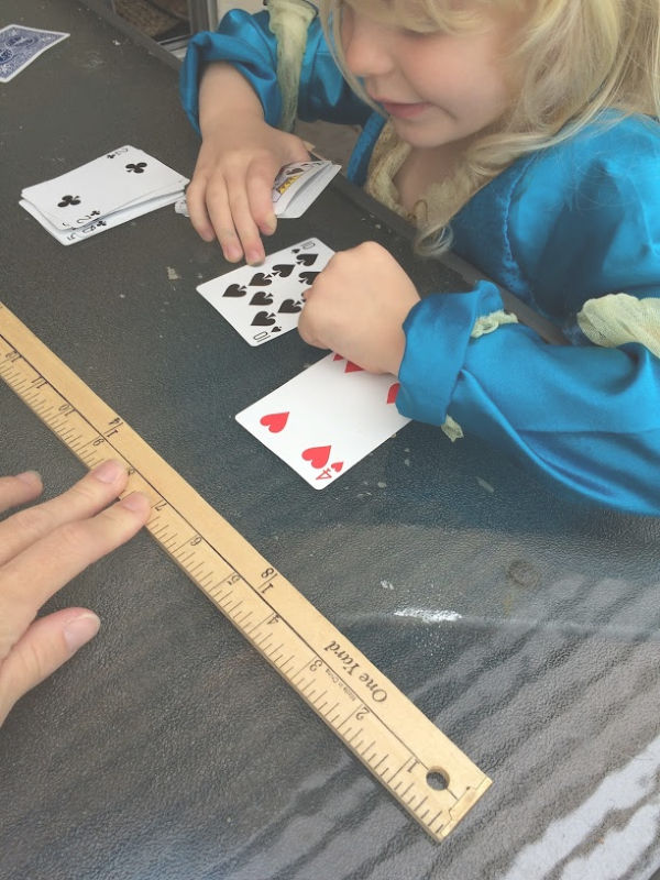 Learning greater than less than with playing cards builds number sense and math skills with a hands-on activity for kindergarten and early elementary age kids.