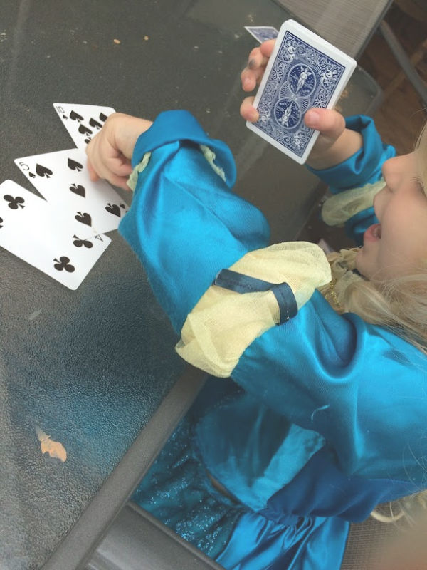 Learning greater than less than with playing cards builds number sense and math skills with a hands-on activity for kindergarten and early elementary age kids.