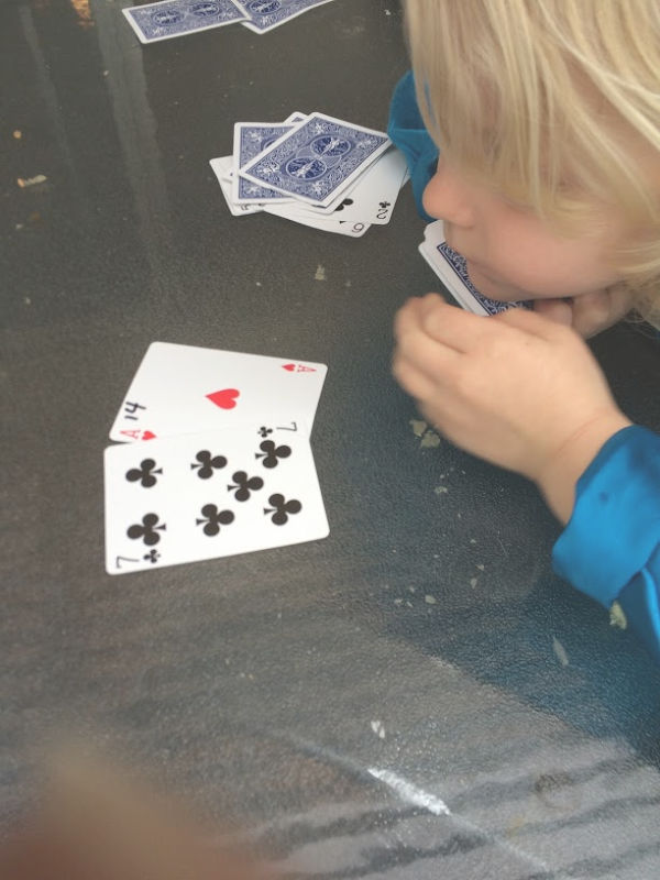 Learning greater than less than with playing cards builds number sense and math skills with a hands-on activity for kindergarten and early elementary age kids.