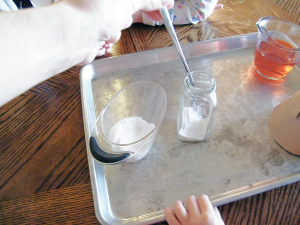 Preparing the supplies for making and exploring a volcano in this geology unit for kids.