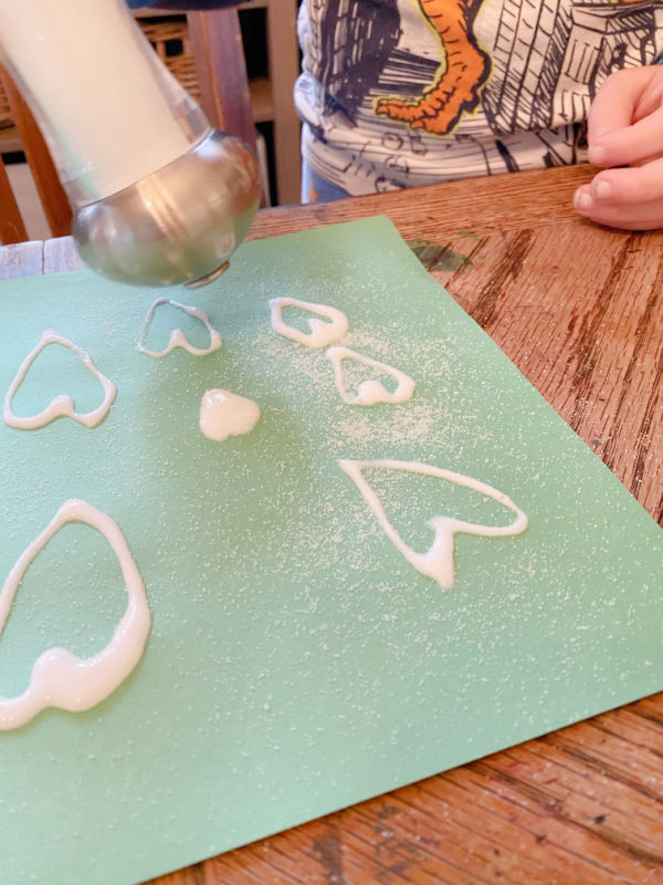 Sprinkling salt onto glue drawings.