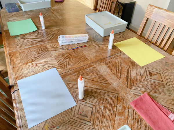 Table set up with supplies for the Valentines salt and watercolor painting activity.