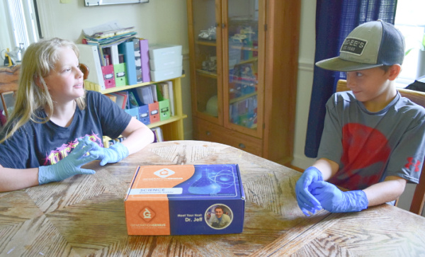 Multiple children can explore hands-on science experiments with video-based instructions in a Generation Genius science kit.