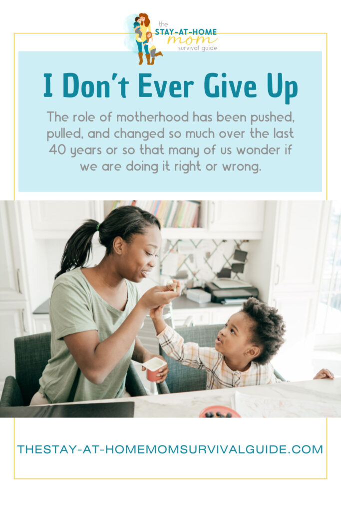 Mother feeding her toddler yogurt. Text reads I don't ever give up the role of motherhood has been pushed and pulled over the last 40 years, so many of us wonder if we are doing it wrong.