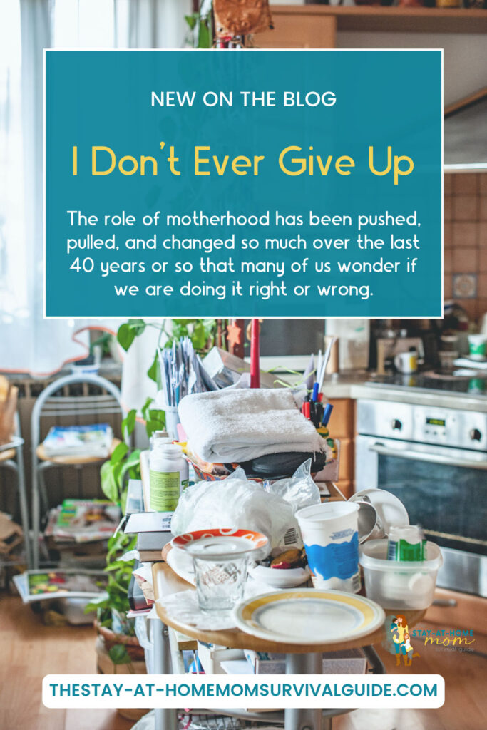 A pile of dishes and items on the kitchen counter. Text reads I don't ever give up as a mom.