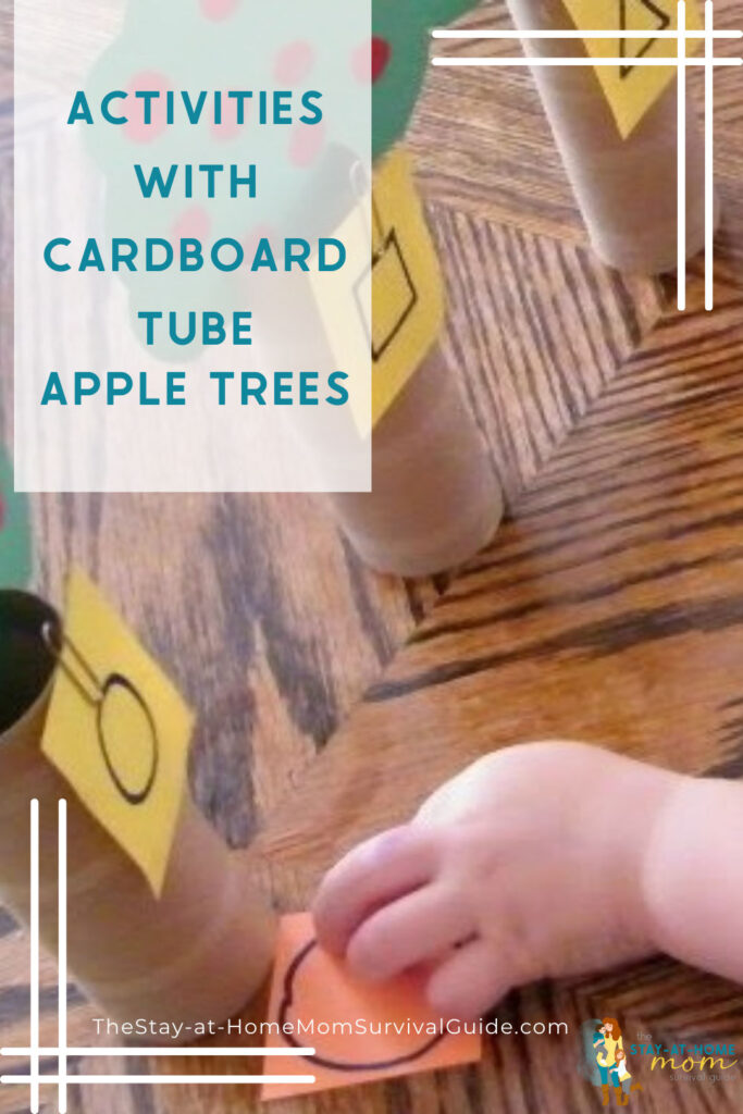 Child matching shapes with cardboard tube apple trees.