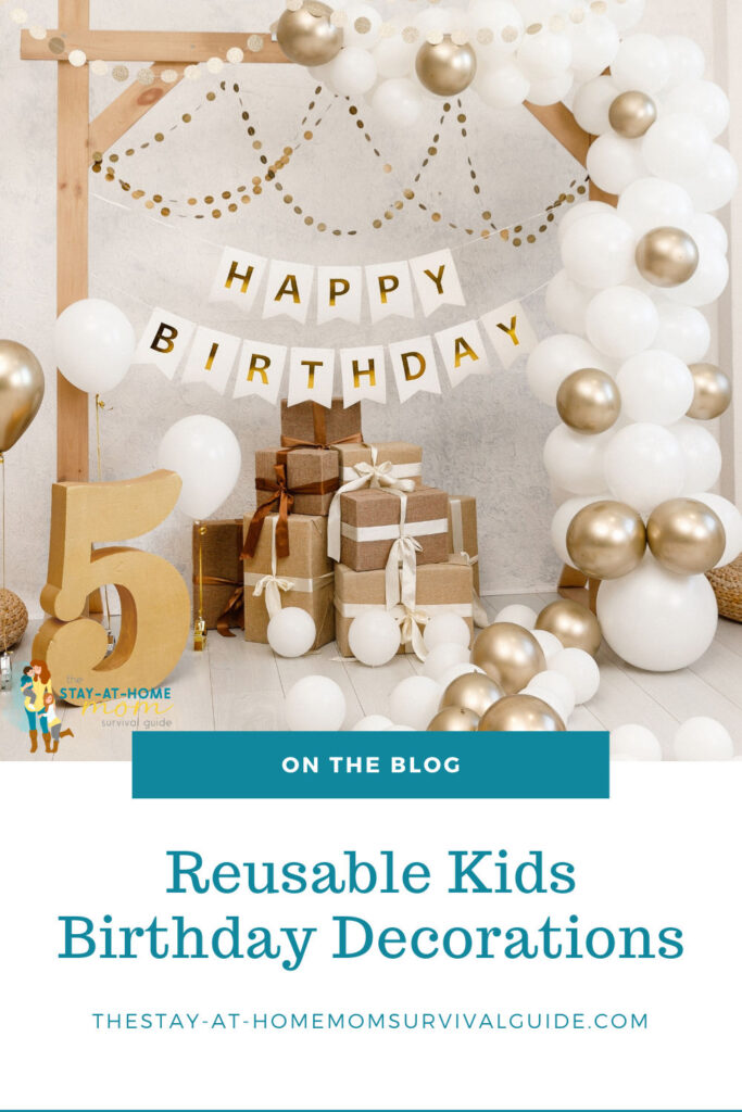 Birthday decorations in gold, white and tan tones on display for a photo wall. Text reads reusable kids birthday decorations.
