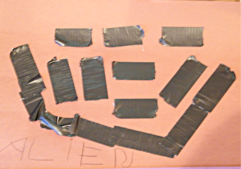 Duct tape pieces stuck onto brown construction paper.