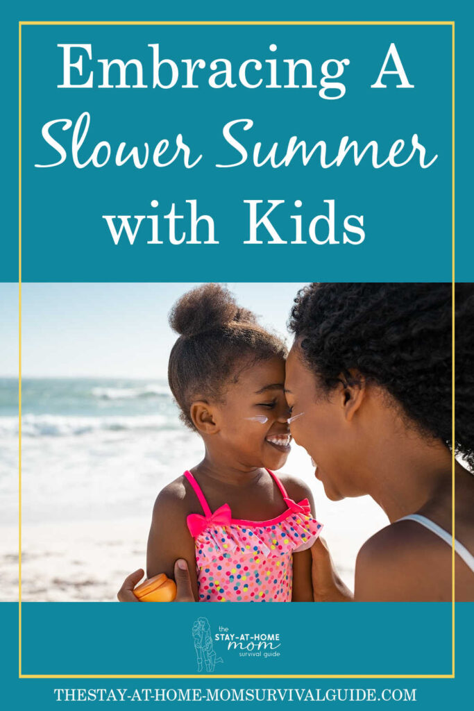 Mom and daughter smiling together on the beach. Text reads embracing a slower summer with kids. 