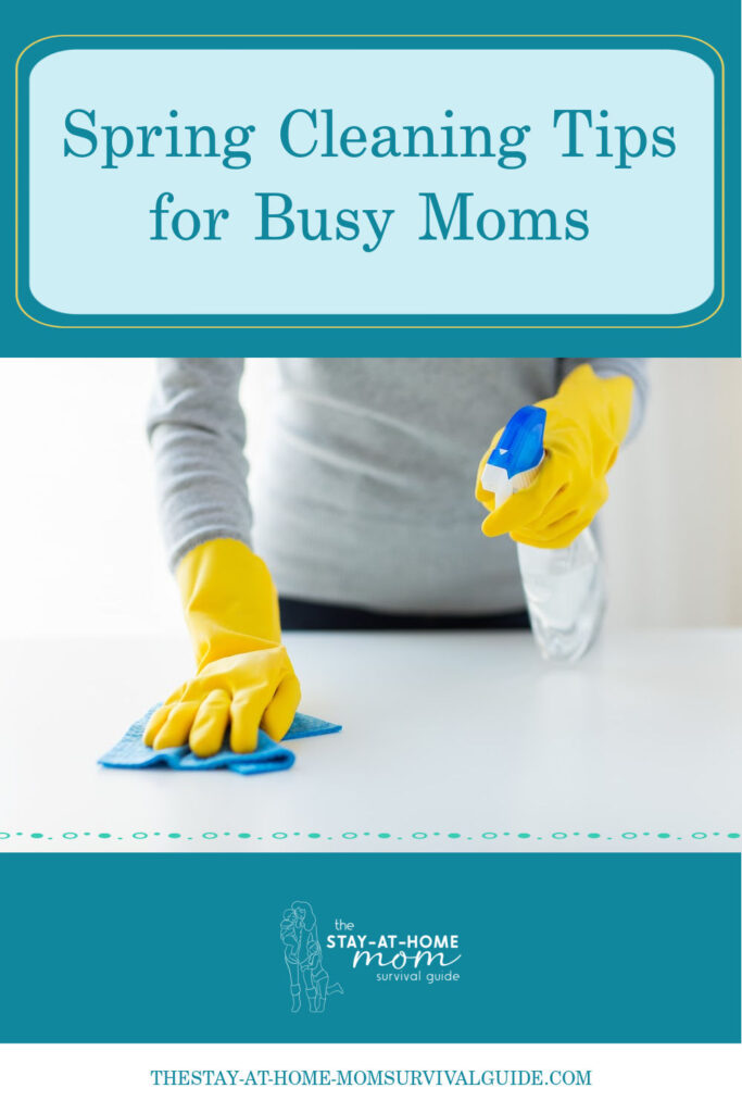 Woman wearing cleaning gloves wiping down a surface. Text reads spring cleaning tips for busy moms.