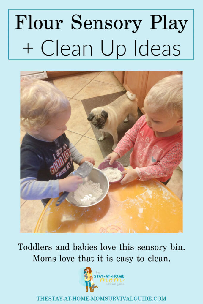 Toddlers standing around a child sized round table. Playing with flour as as sensory bin idea. Text reads flour sensory bin and clean up ideas.