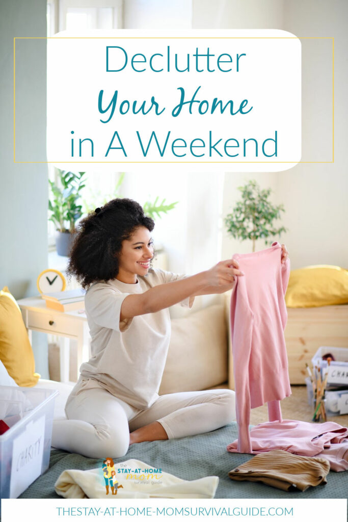 Woman seated on the floor sorting her clothes into piles. Text reads declutter your home in a weekend.
