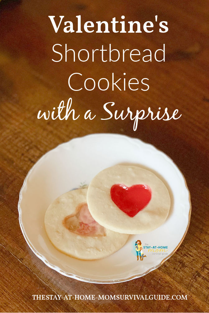 Two Valentine's cutout cookies on a plate. Text reads Valentine's shortbread cookies with a surprise.