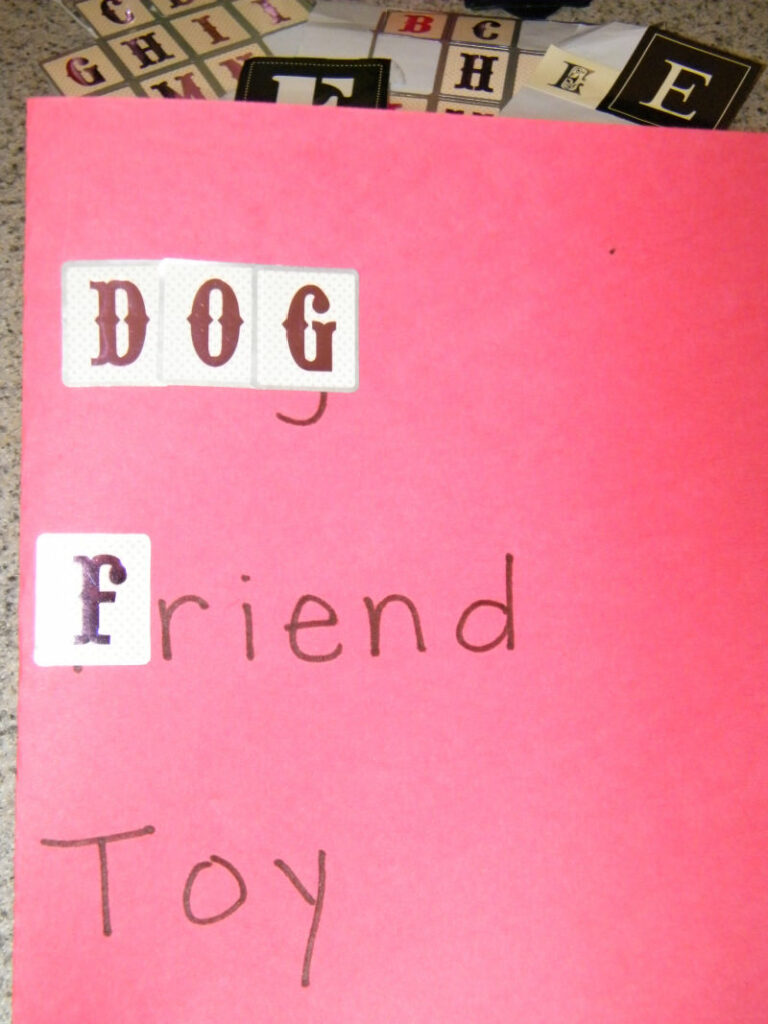 Sticker spelling activity shown with stickers covering written letters.