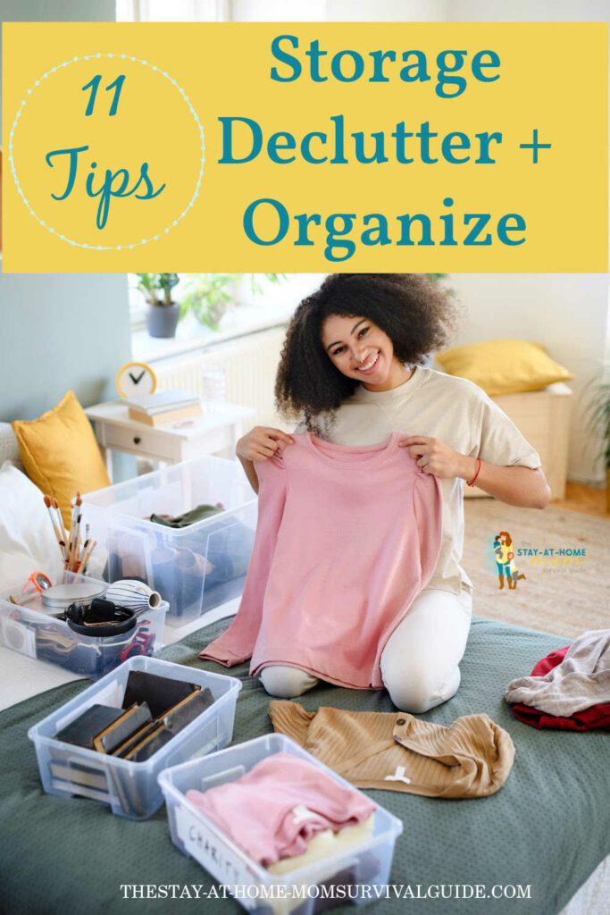 Woman holding up a pink sweater with plastic storage bins arranged around her as she is sorting clothes. Text reads 11 tips storage declutter plus organize.