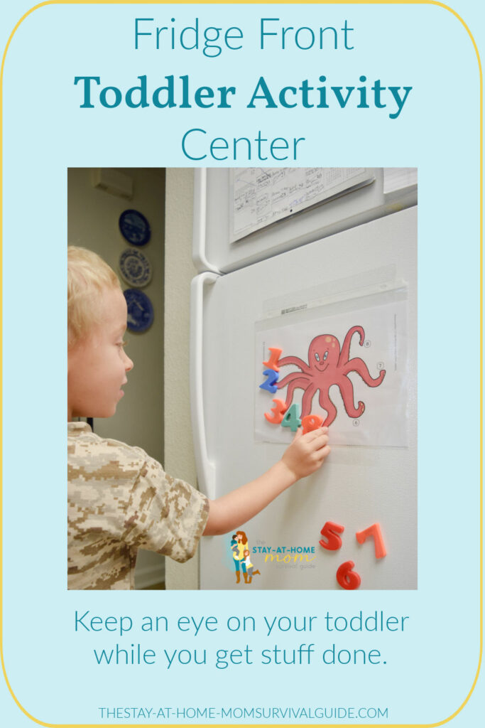 Toddler placing magnets in number order on a mat attached to the front of the fridge. Text reads fridge front toddler activity center play space for toddlers idea.