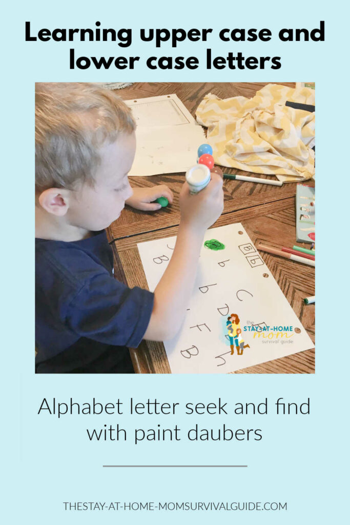 Preschool boy using a paint dauber to identify upper case and lower case letters in a seek and find activity. 