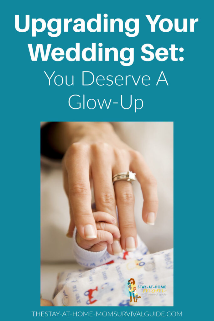 A woman's hand with a diamond ring on her ring finger is being held by an infants grasp. Text reads upgrading your wedding set you deserve a glow-up.